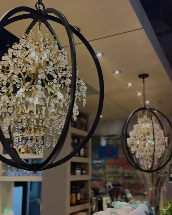 Evening interior of Kawa Espresso Bar under chandeliers and low light